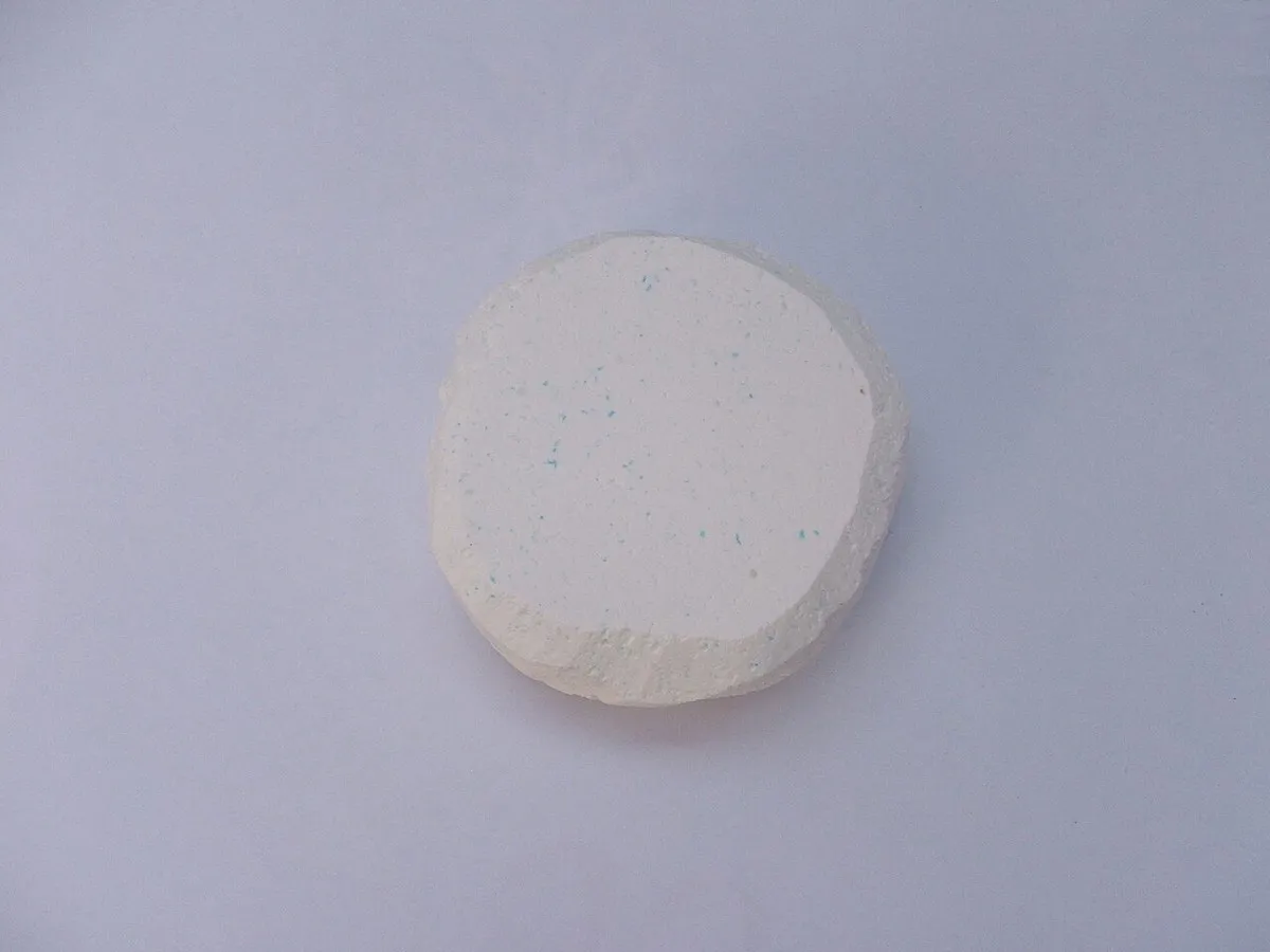 Pastilla de cloro blanca para piscina sobre fondo claro
